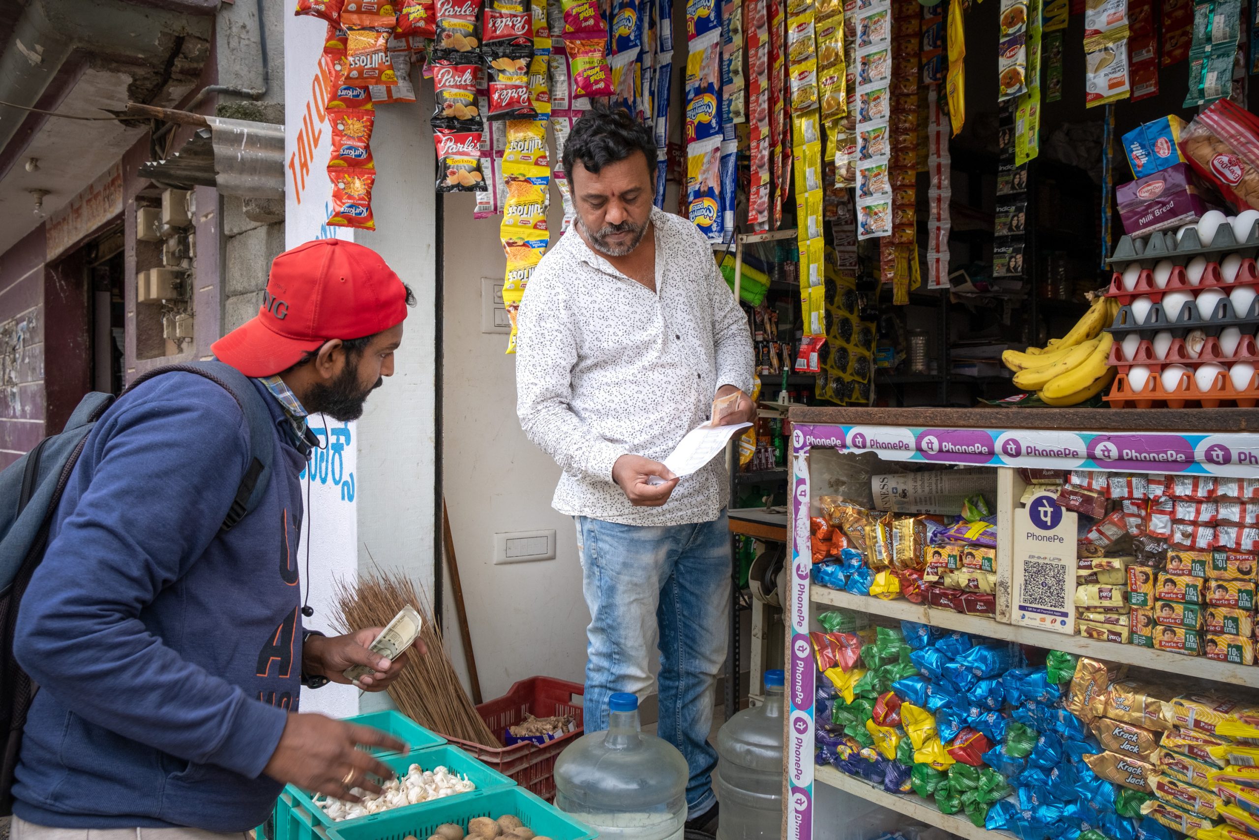 Jayappa S. in front of his store with customer